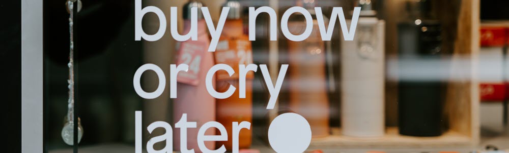 Sign says Buy Now or Cry Later on How To Buy Art Guides page